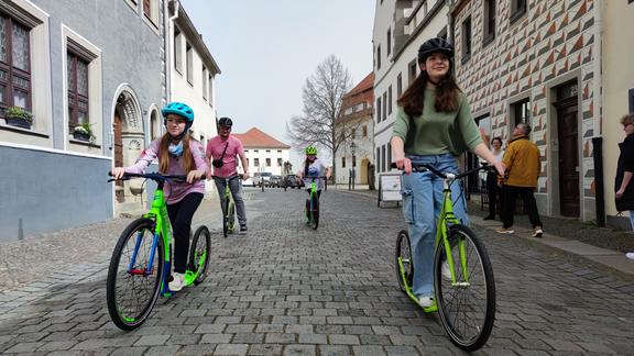 Kinder fahren Tretroller in der Torgauer Innenstadt